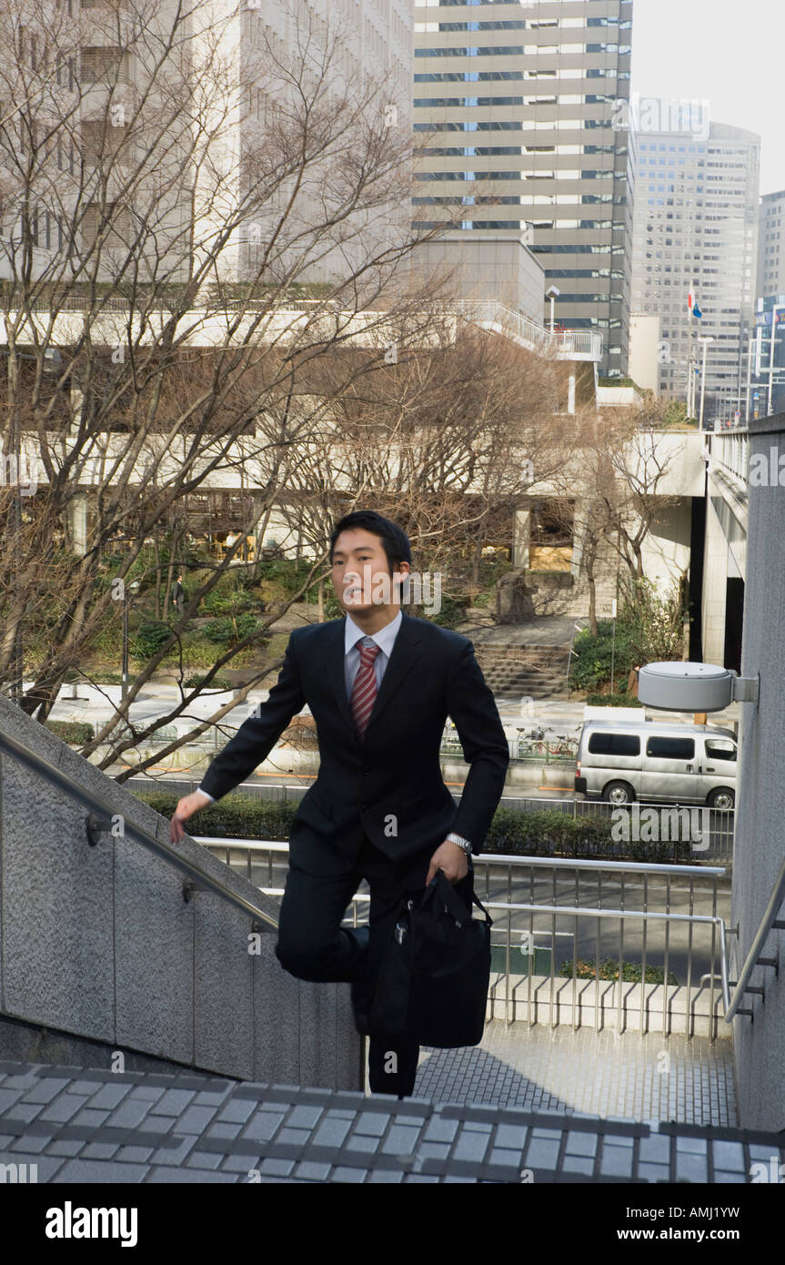 Businessman running up stairs Stock Photo - Alamy