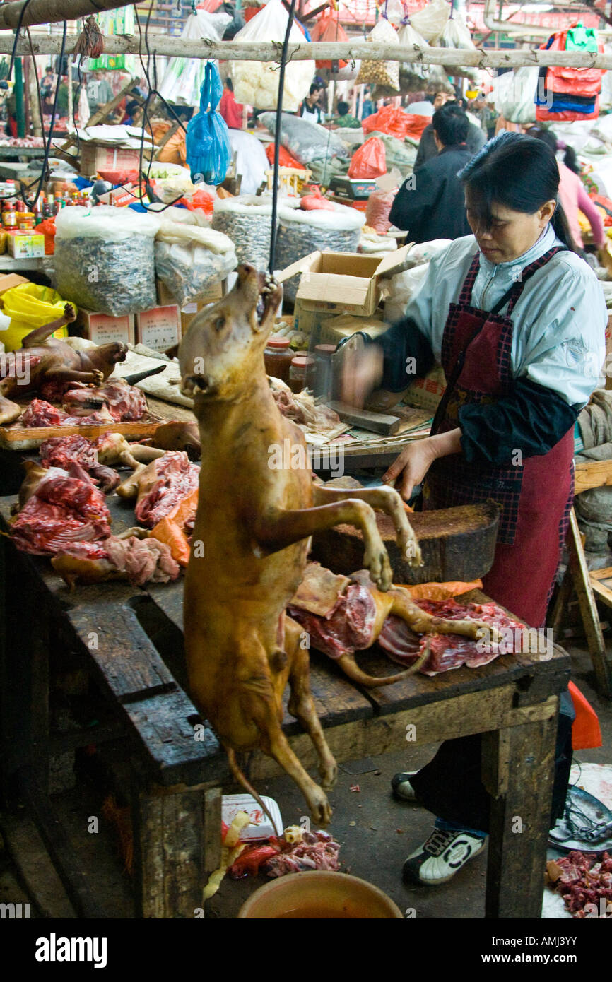 Woman Butchering a Dog for Meat in a Local Market Yangshuo China Stock Photo