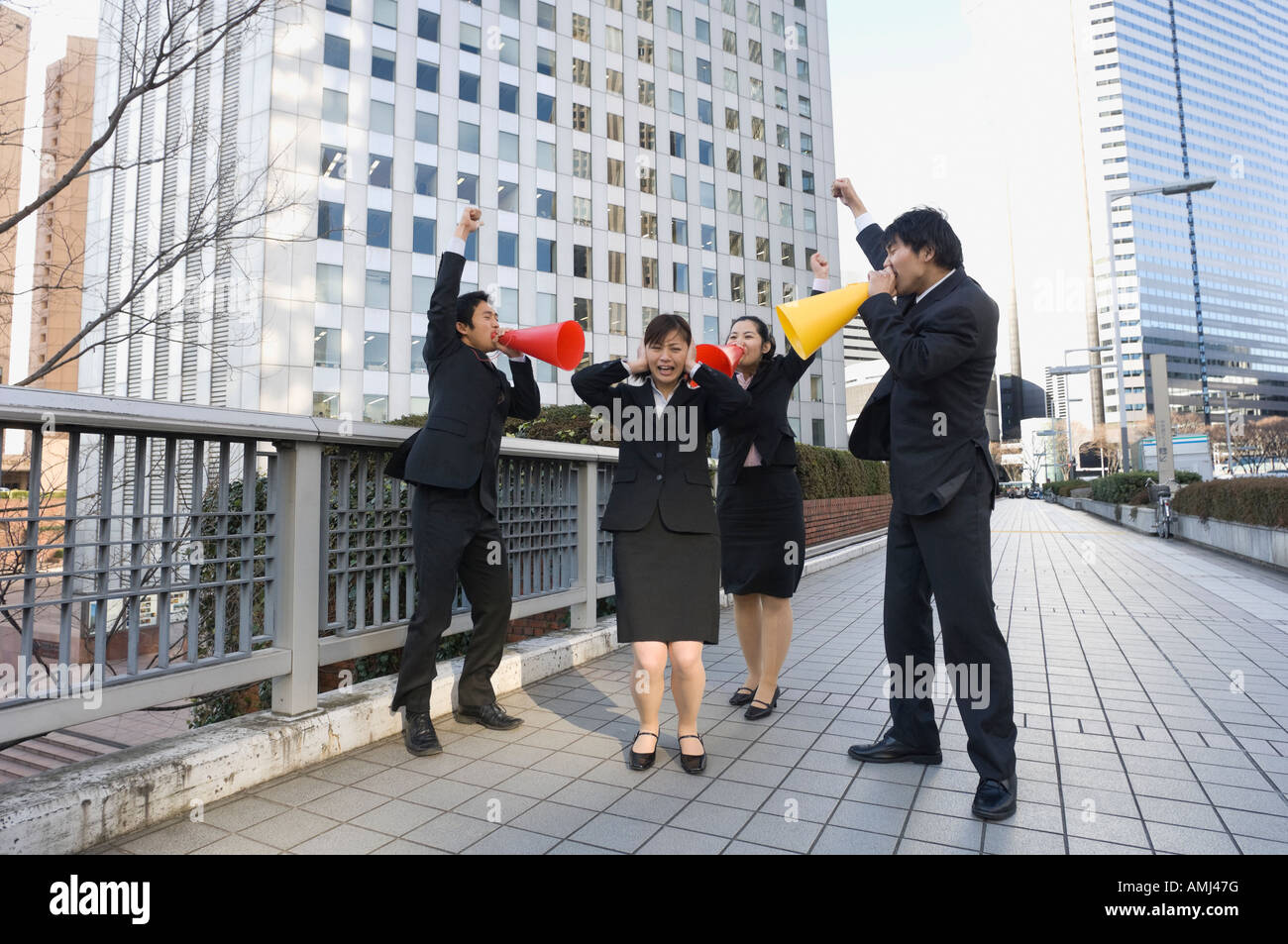 Group of business people shouting at colleague Stock Photo
