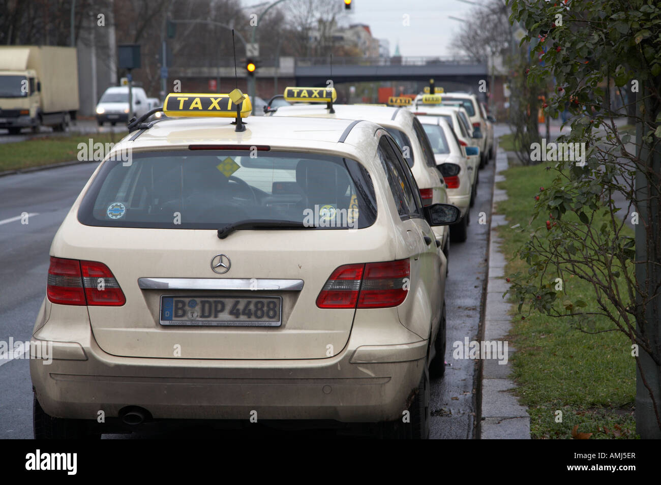 row of berliner taxi cabs parked on a dual carriageway outside an underground station rank Berlin Germany Stock Photo