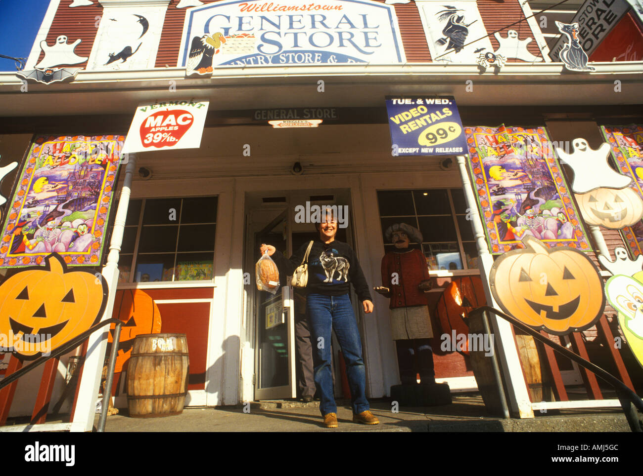 Man On Porch Of Country Store In Williamstown Vt Covered With