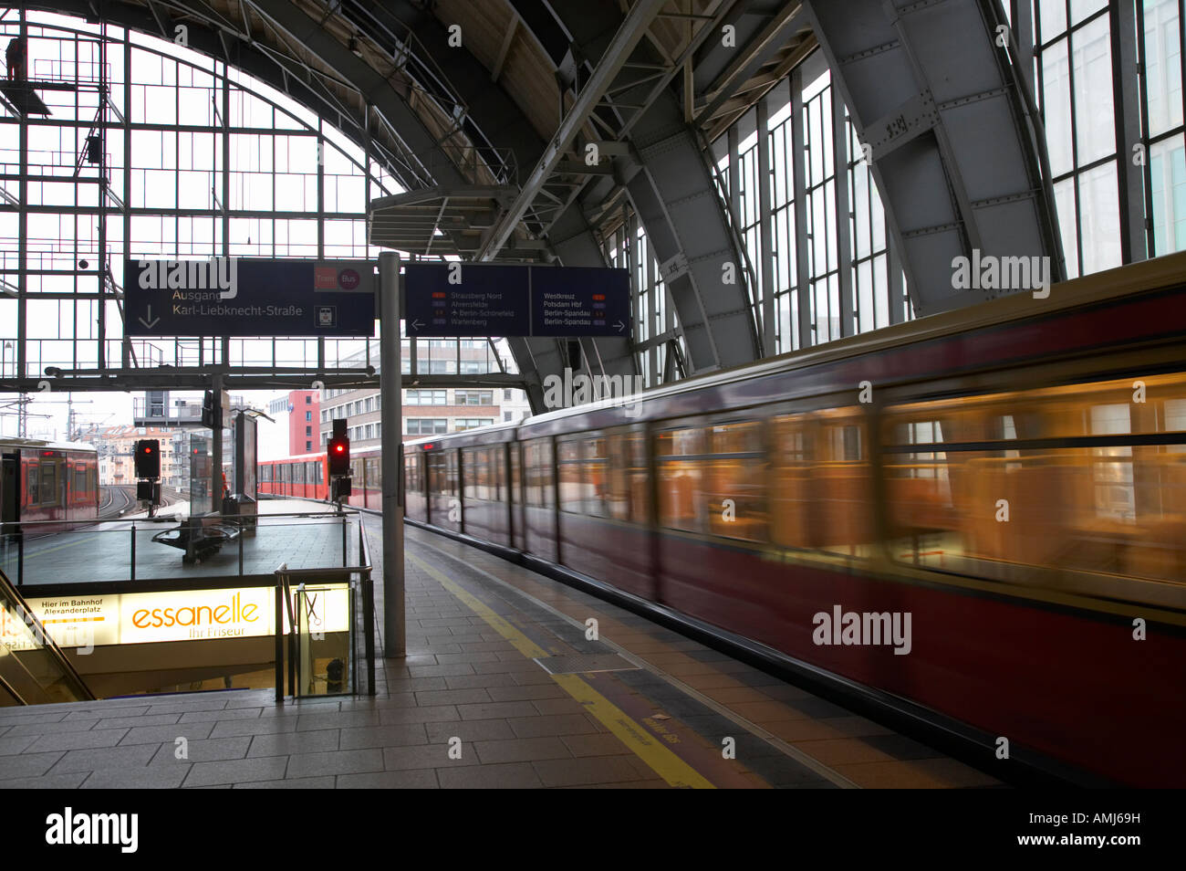 Berlin S Bahn train speeds past platform at Alexanderplatz main train station Germany Stock Photo