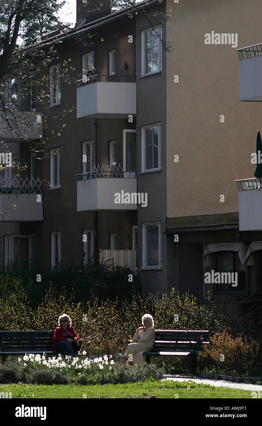 Two old ladies resting outside an apartment building. Stock Photo