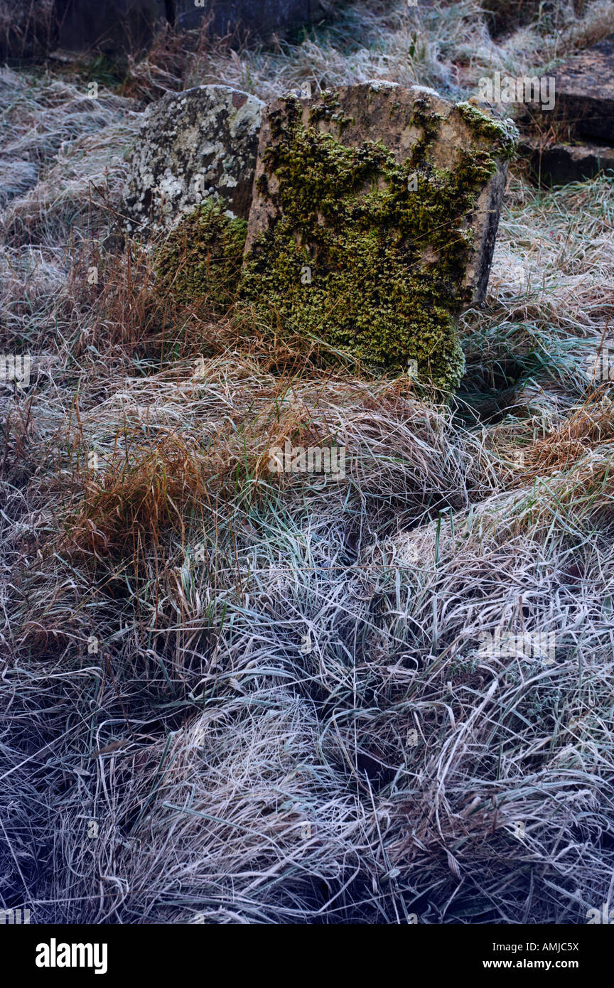 Graves in frosted grass at St Andrew s Church Castle Combe, Wiltshire England Stock Photo