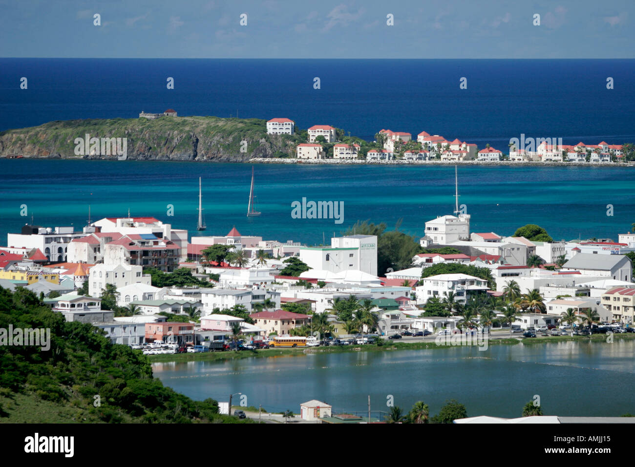 Philipsburg St Maarten with Salt Pond in foreground and Great Bay Fort Amsterdam on rocky outcrop beyond Stock Photo