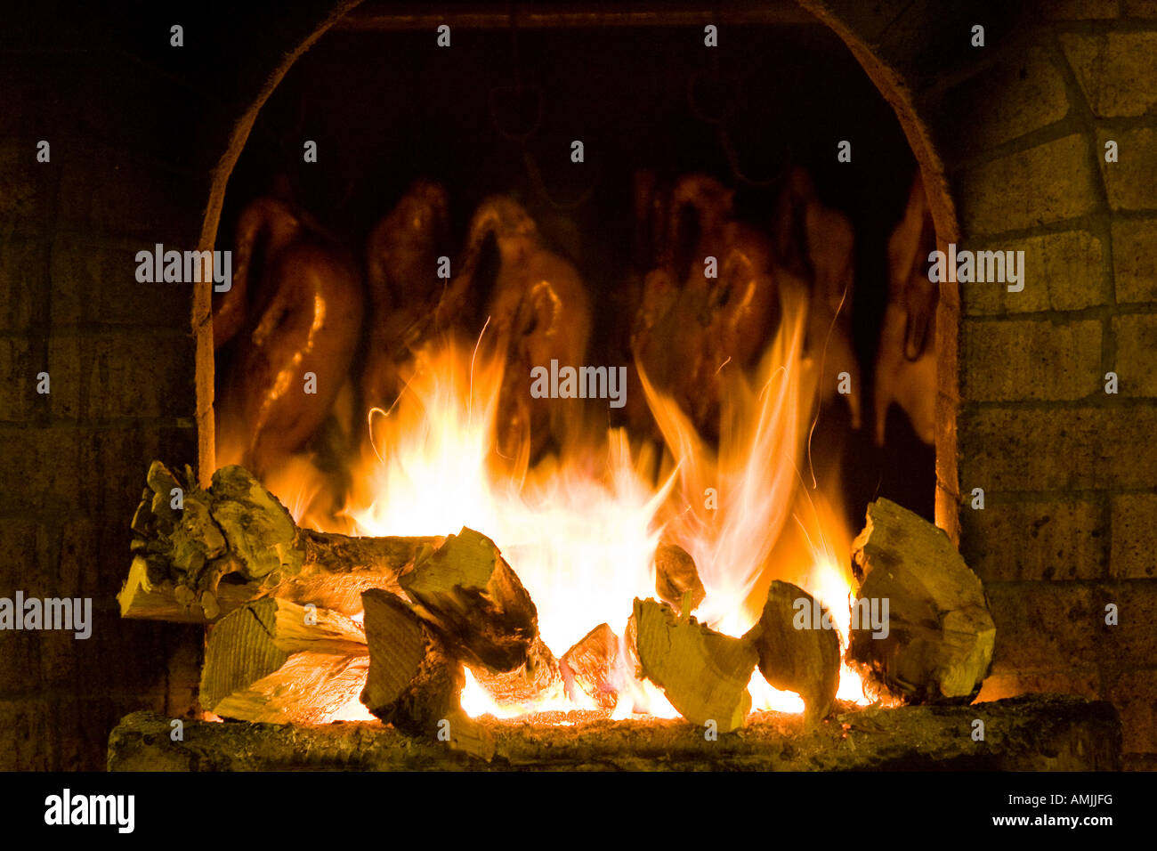 Peking Duck Roasting in Stone Oven on Wood Fire Beijing China Stock Photo