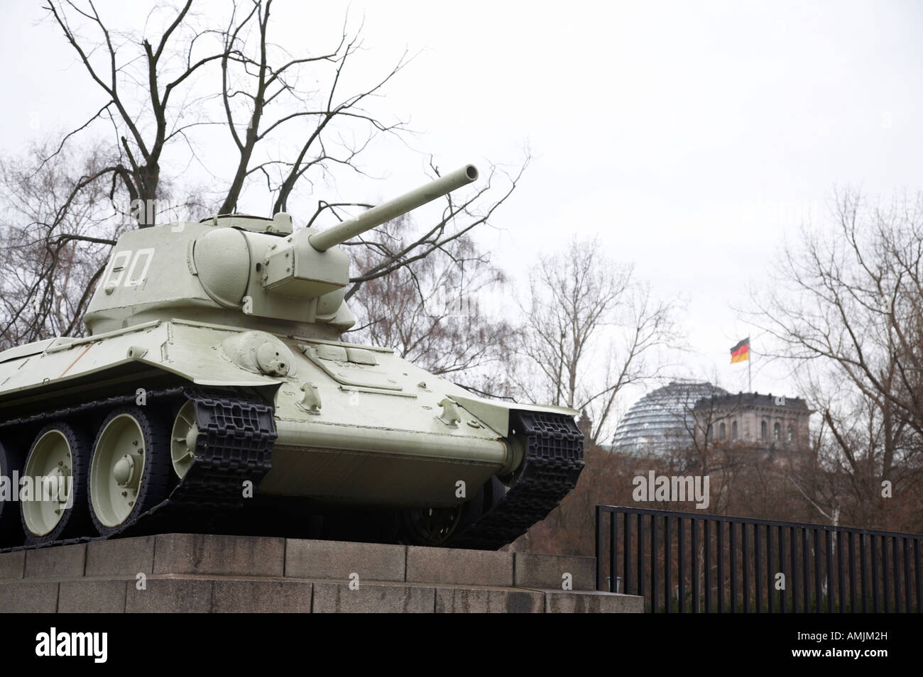 T 34 tank of the soviet war memorial tiergarten with the Reichstag in the background Berlin Germany taken in the early 1990s Stock Photo