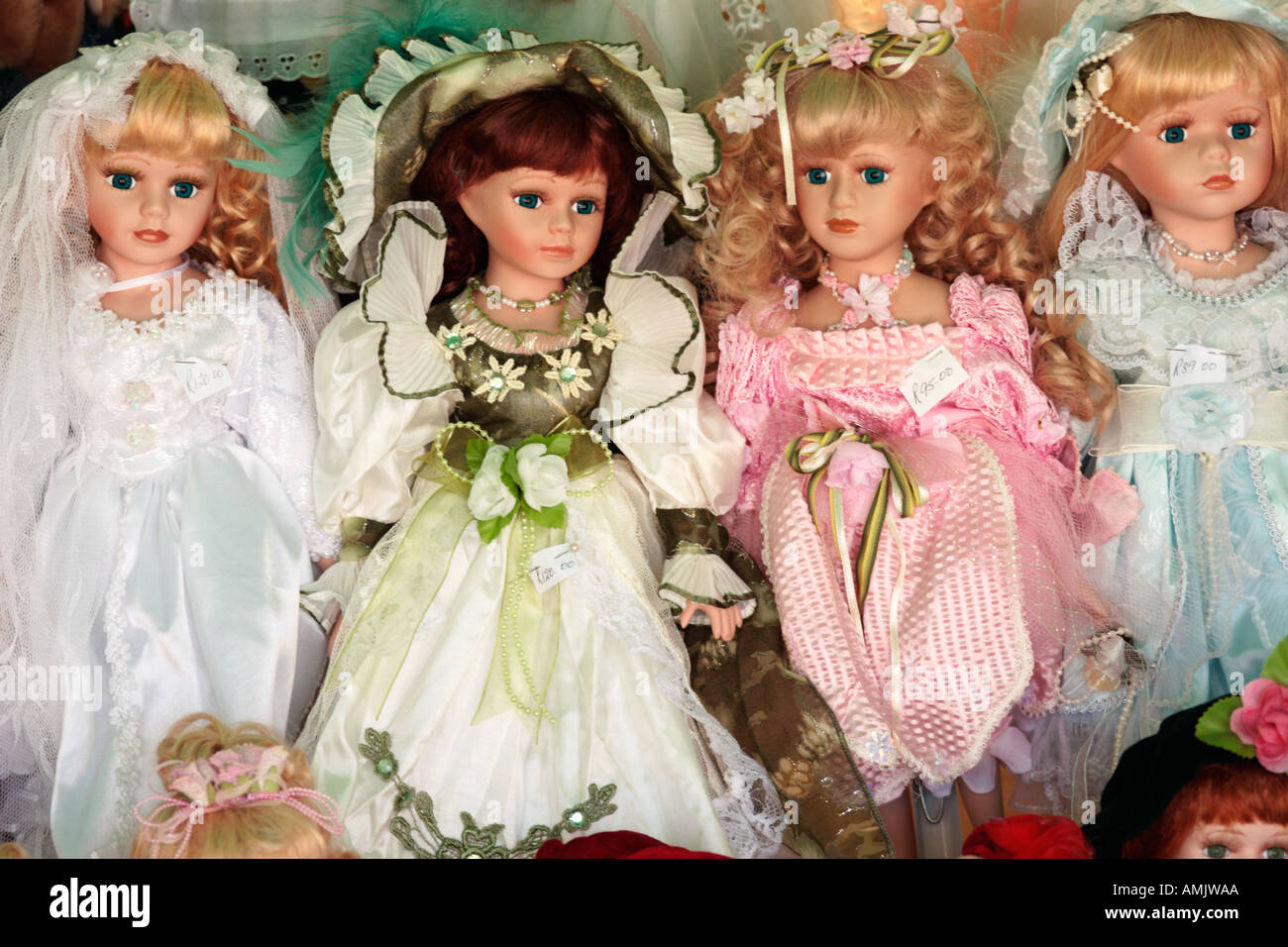 Four Porcelain dolls in shop window Stock Photo