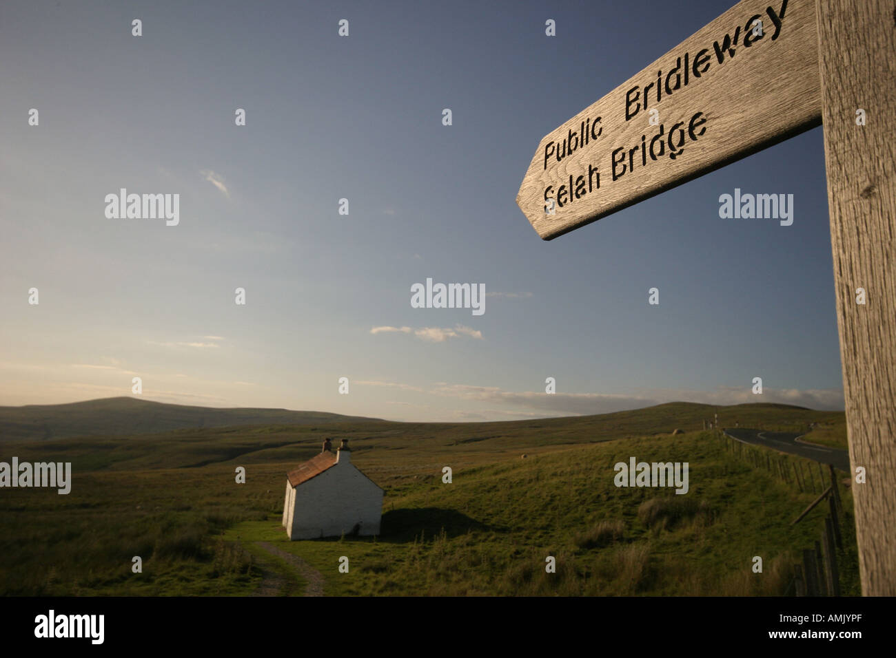 A Stock Photograph of a Sign for a Footpath and a House on top of the Pennines in Cumbria UK Stock Photo
