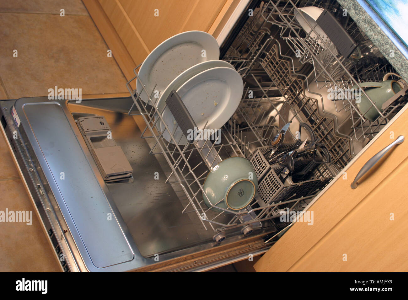 a dishwasher full of dirty cutlery Stock Photo Alamy