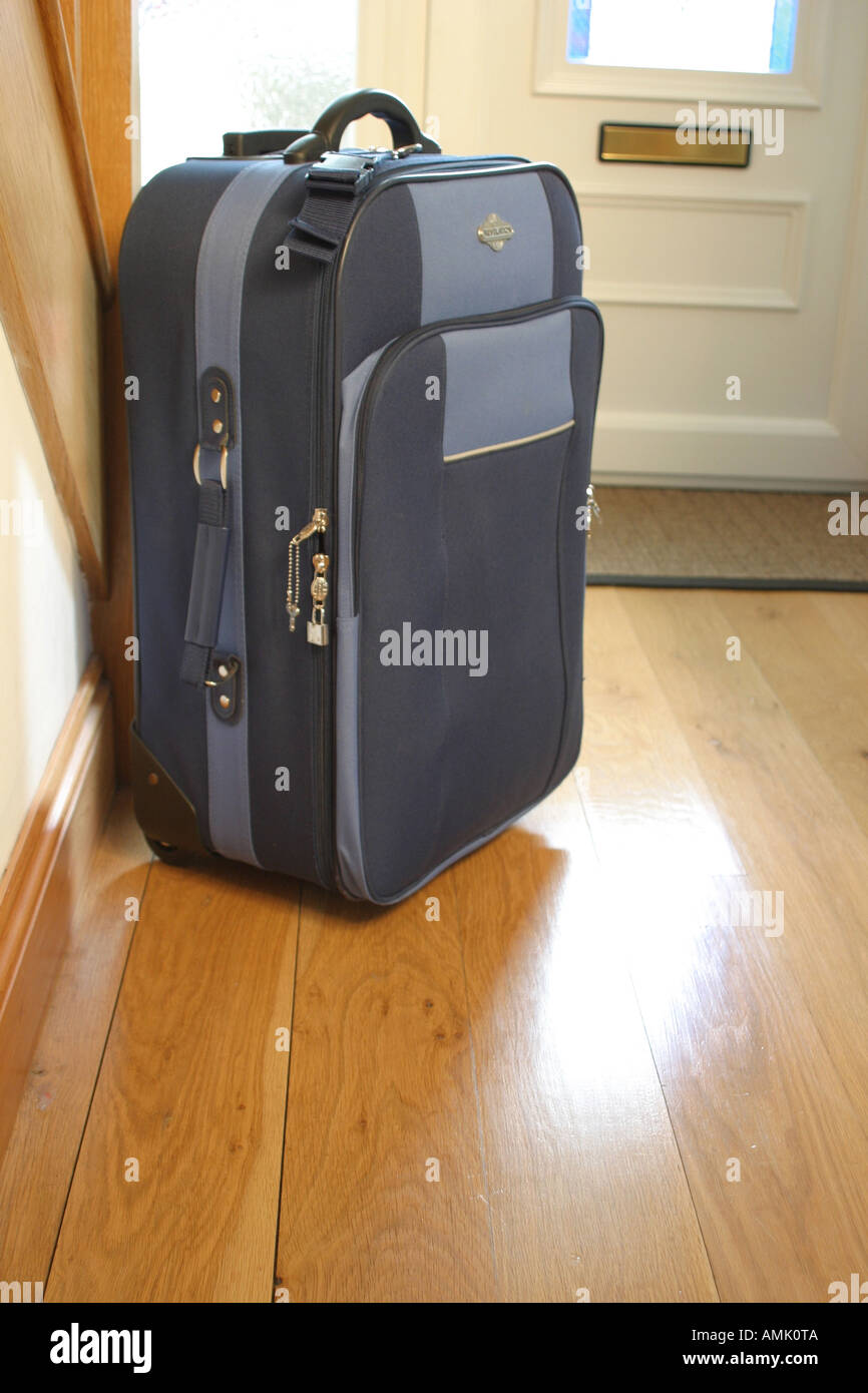 suitcase at a front door Stock Photo Alamy