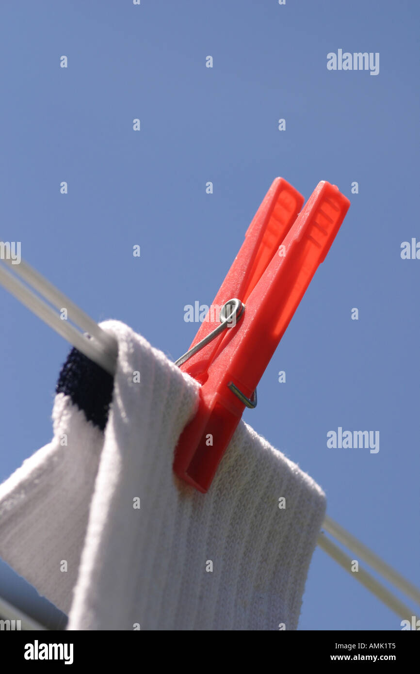 A stock photograph of a washing peg holding a sock on the line Stock Photo Alamy