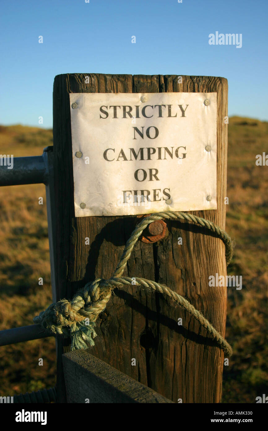 Strictly No Camping or Fires warning sign on a gate post by the road at High Hauxley Northumberland United Kingdom UK Stock Photo