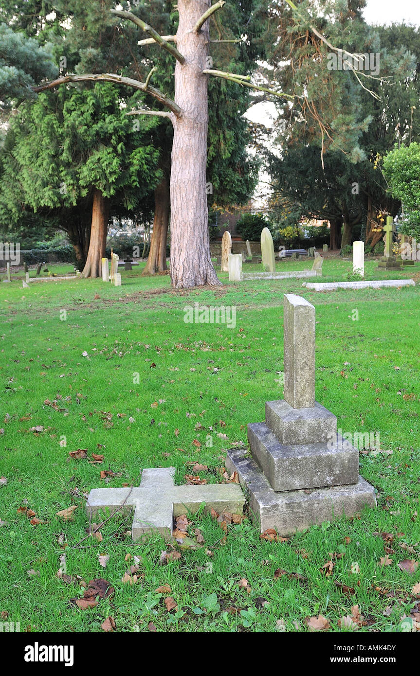 Fallen down cross tombstone Stock Photo