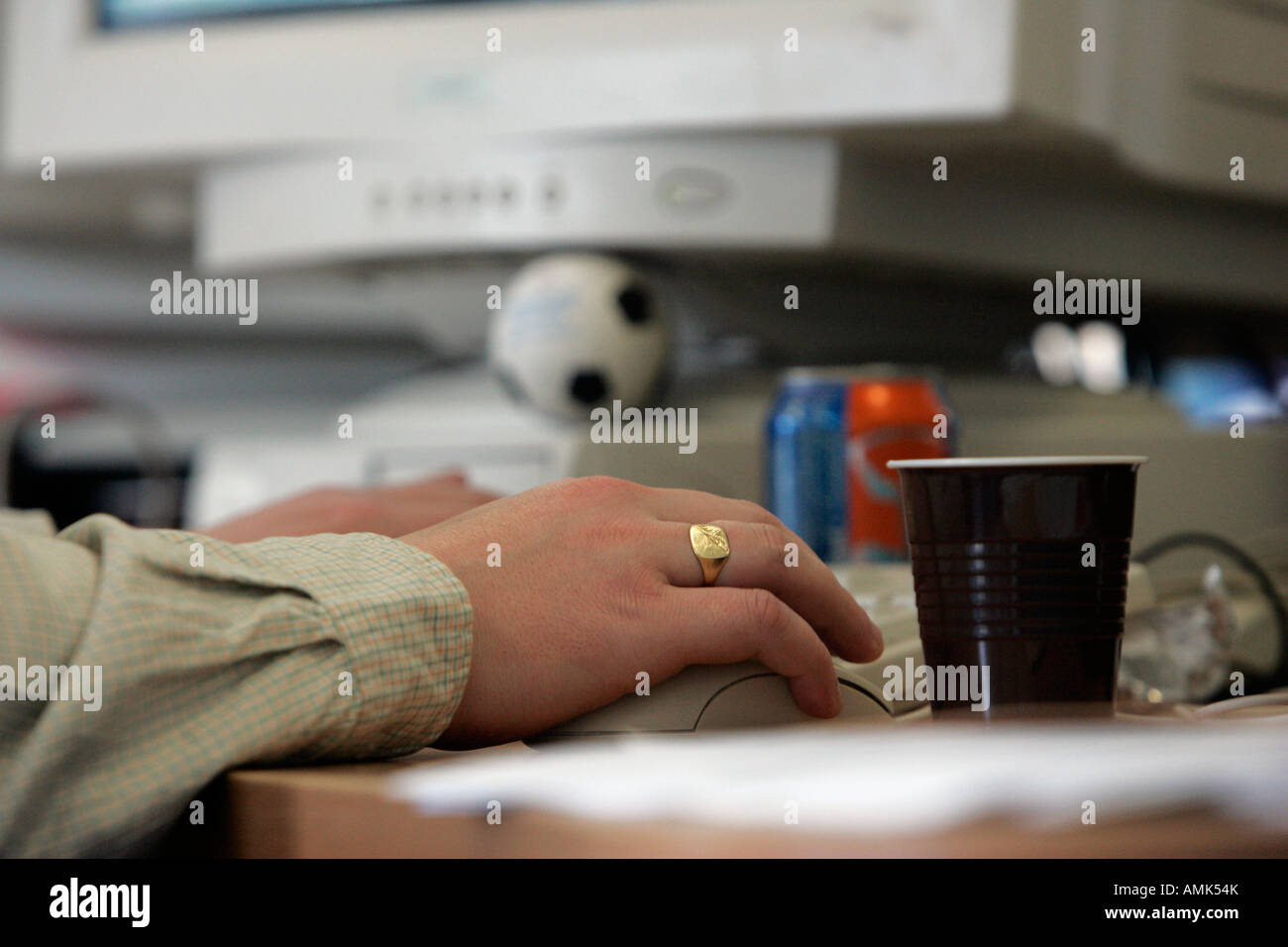 CLOSE-UP OF AN OFFICE WORKER'S HANDS USING A COMPUTER KEYBOARD. Stock Photo