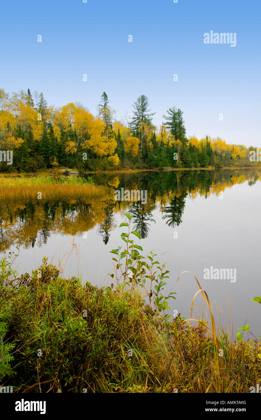 A calm inland lake with fall foliage and reflections in rural Minnesota ...