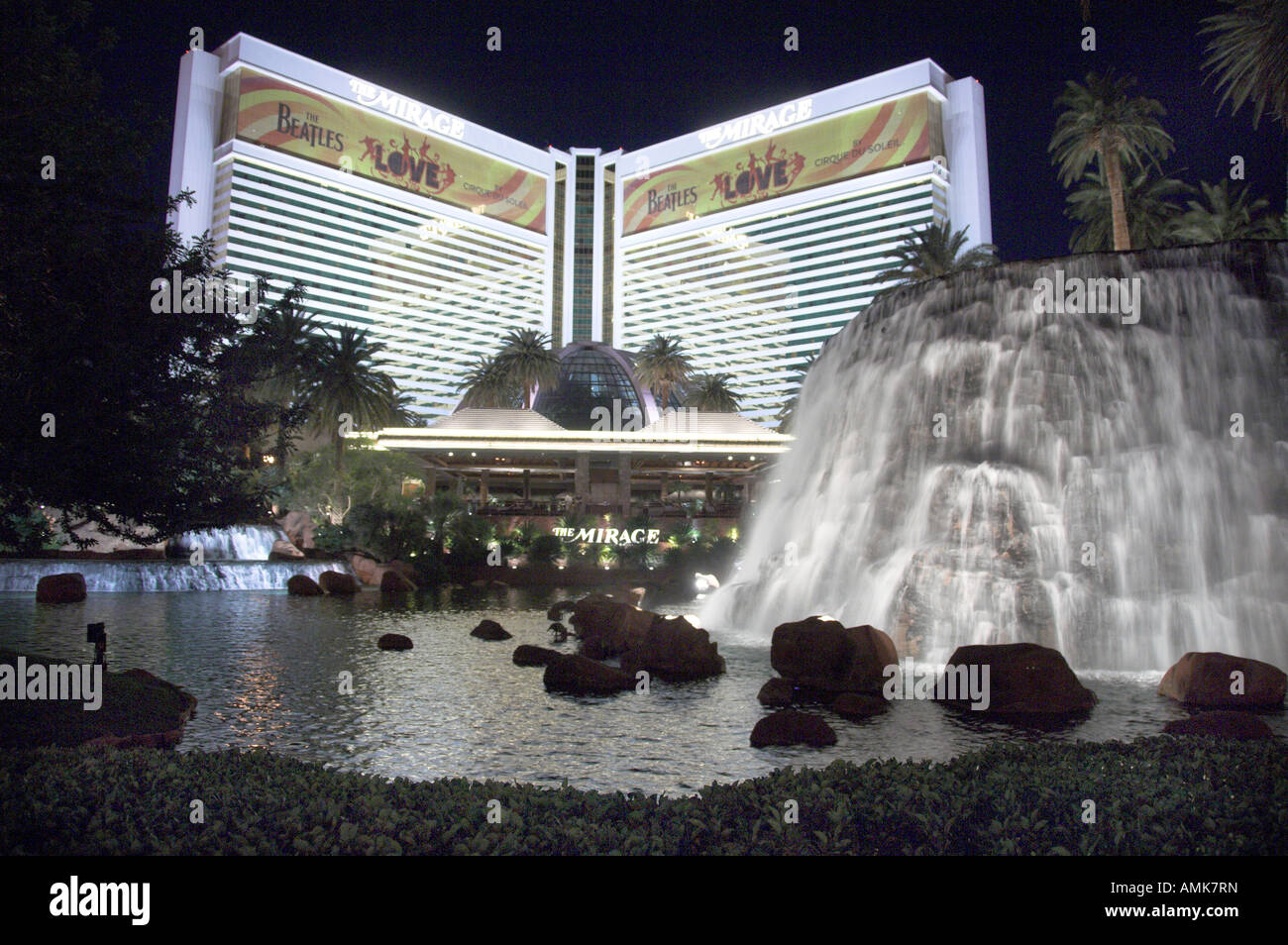 The Mirage Hotel and Casino with water falls and reflections at dusk on The Strip in Las Vegas Nevada USA Stock Photo