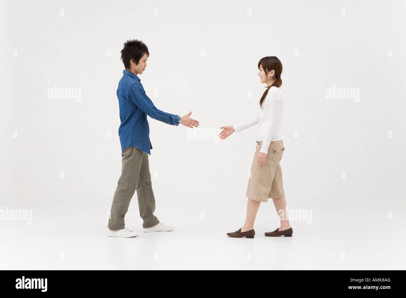 Extend Handshake Two young people extending handshake Stock Photo - Alamy