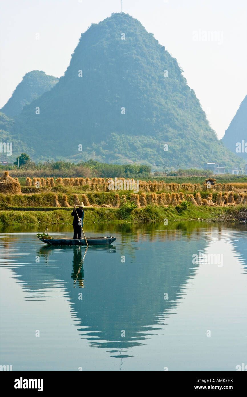 Chinese Farmer on a Bamboo Raft in the Li Jiang River Limestone Karsts Yangshuo China Guangxi Province Stock Photo