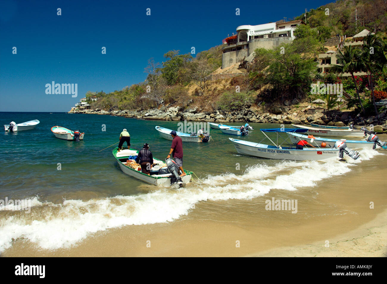 A small sandy beach cove with colorful boats on Banderas Bay south of Puerto Vallarta Mexico Stock Photo