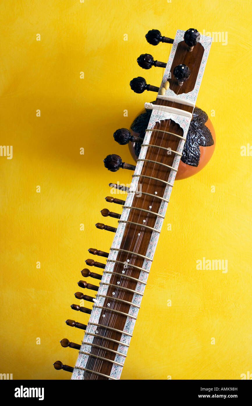 Indian sitar against yellow background Stock Photo Alamy