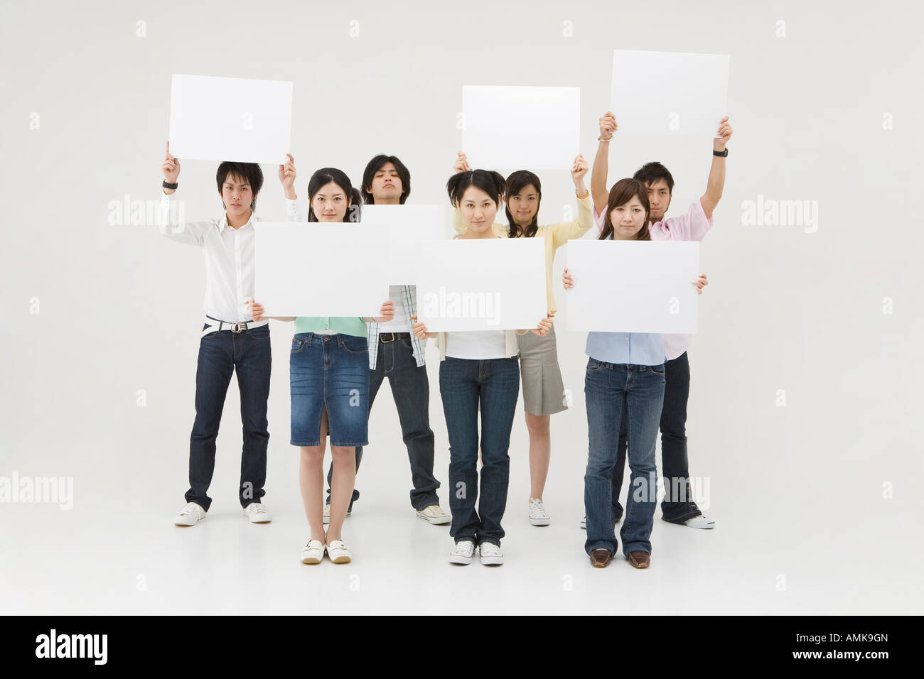 Group of people holding blank message board Stock Photo - Alamy