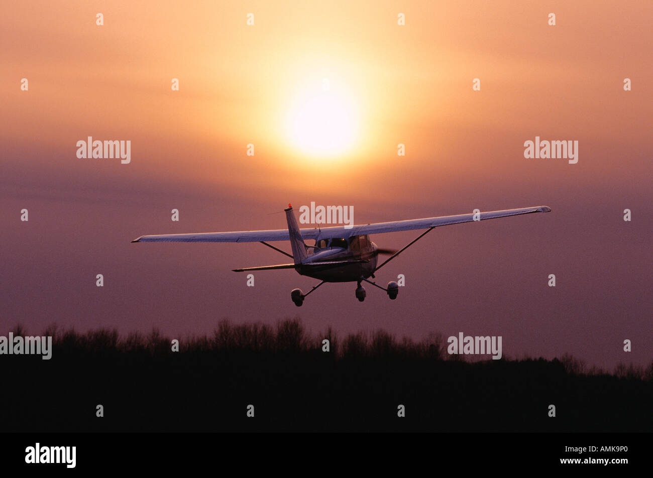 Plane Taking Off at Sunset Stock Photo