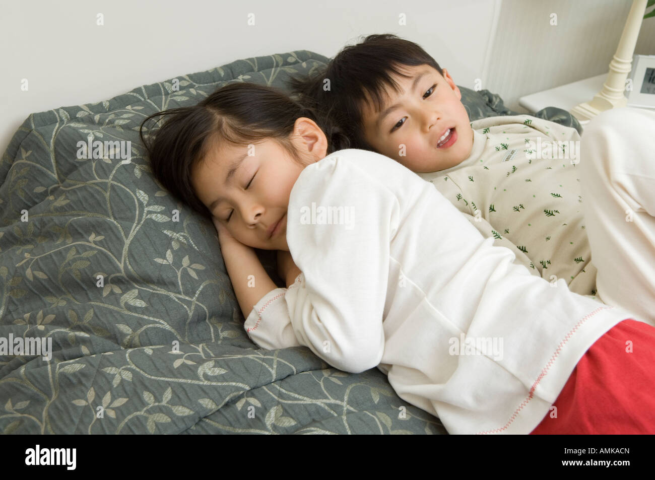 Children sleeping on bed Stock Photo Alamy