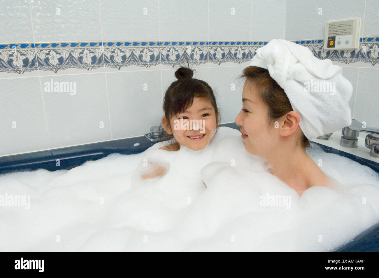 Mother and daughter taking bath Stock Photo