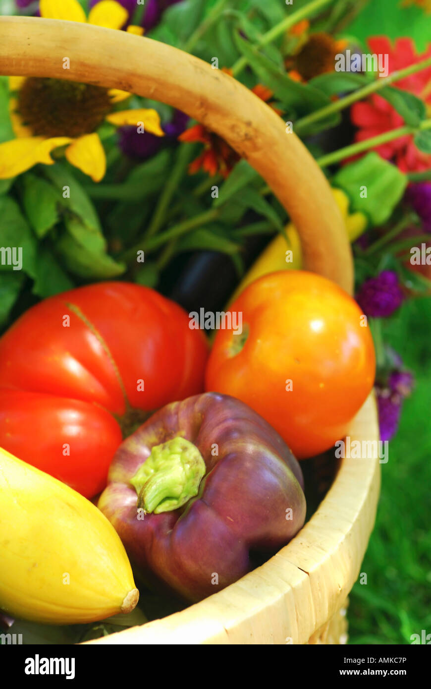 Wicker basket filled with fruits vegetables and flower fresh from the ...