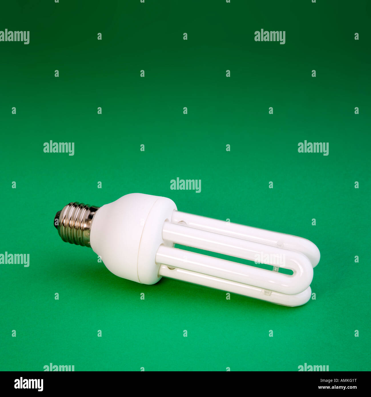 energy efficient light bulb on green background Stock Photo - Alamy