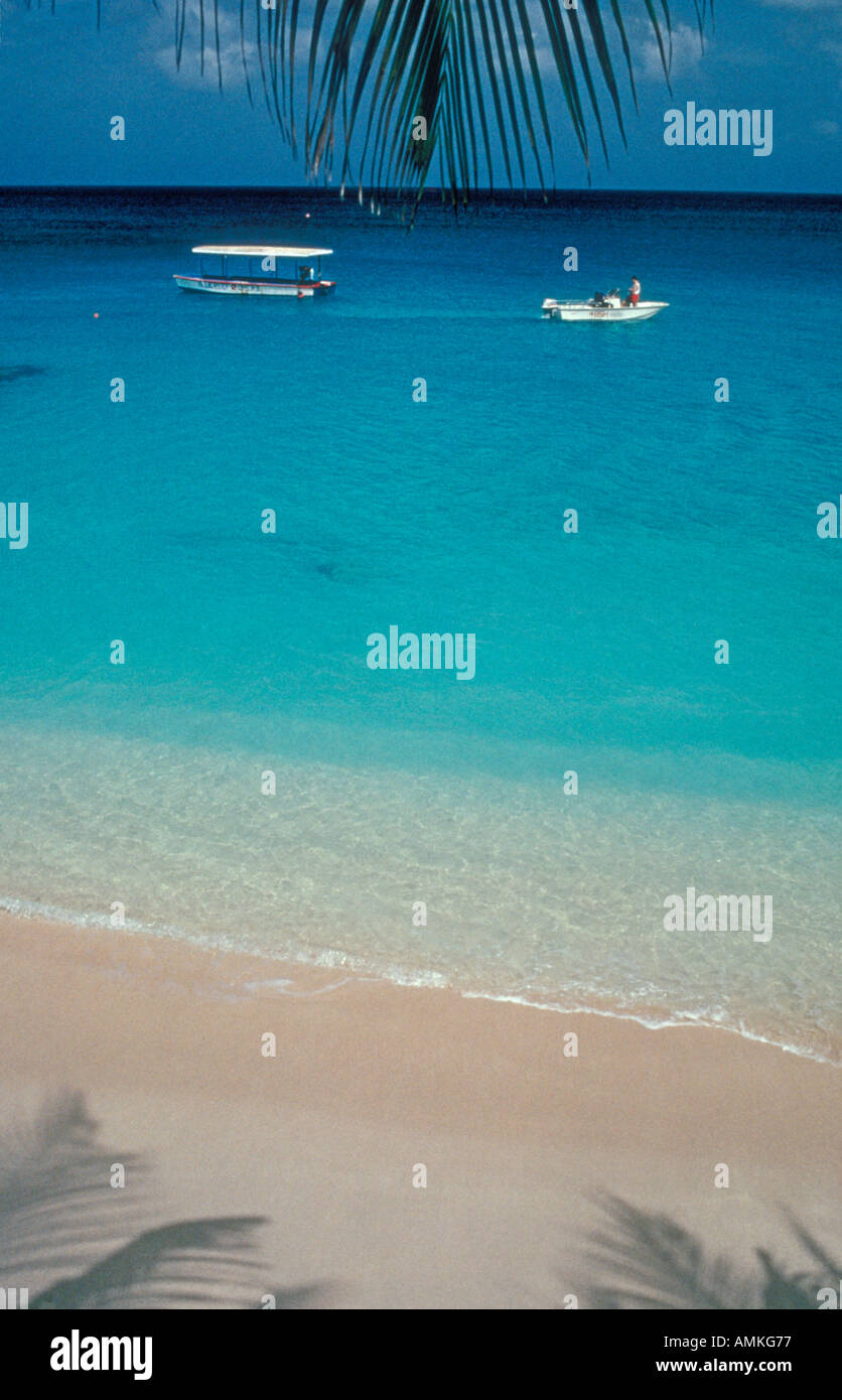 Barbados shoreline with boats at sea and rippling waves on beach, near Speightstown, Barbados, West Indies Stock Photo