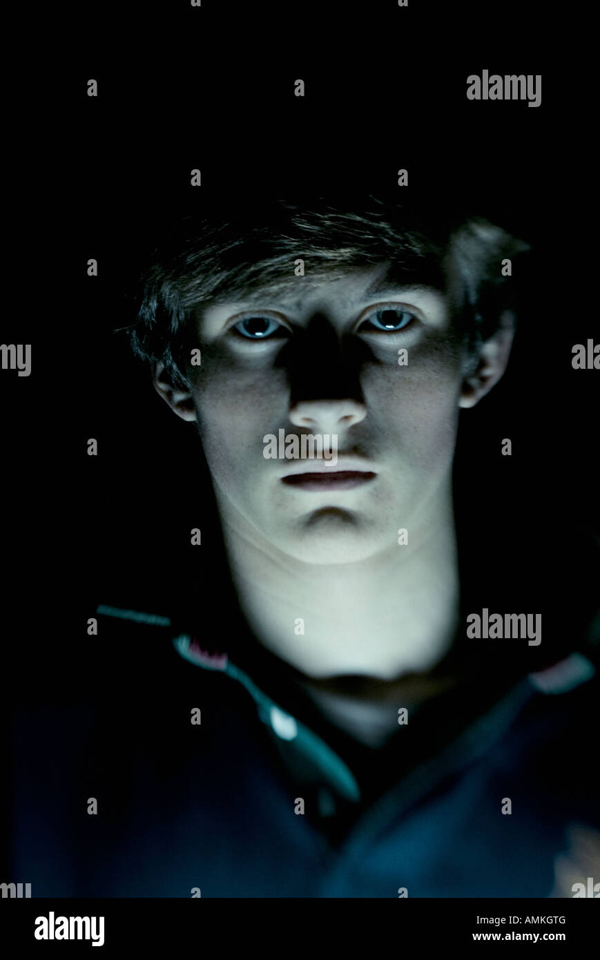 Portrait of a teenage boy lit by a torch Stock Photo - Alamy