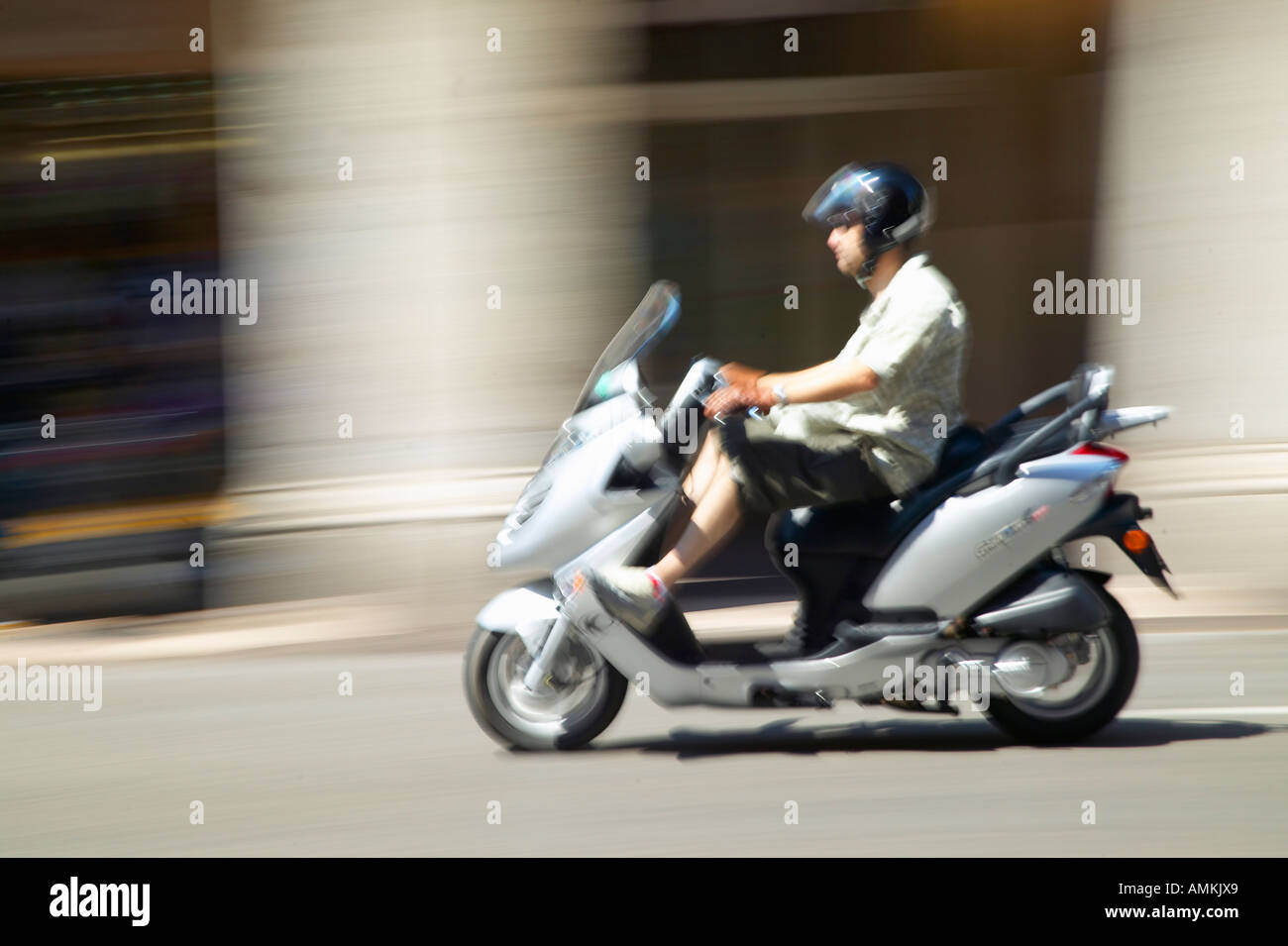 Man riding moped in Nice France Stock Photo - Alamy