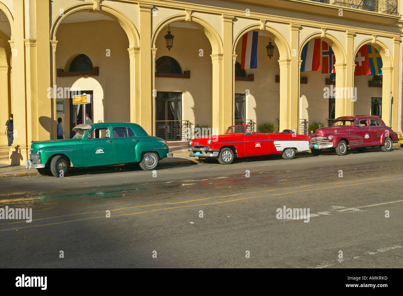 Classic old American cars parked in front of hotel in Old Havana Cuba Stock Photo