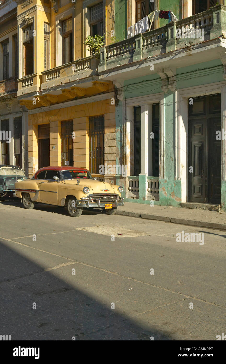 Old Pontiac car parked in front of old buildings in Old Havana Cuba Stock Photo
