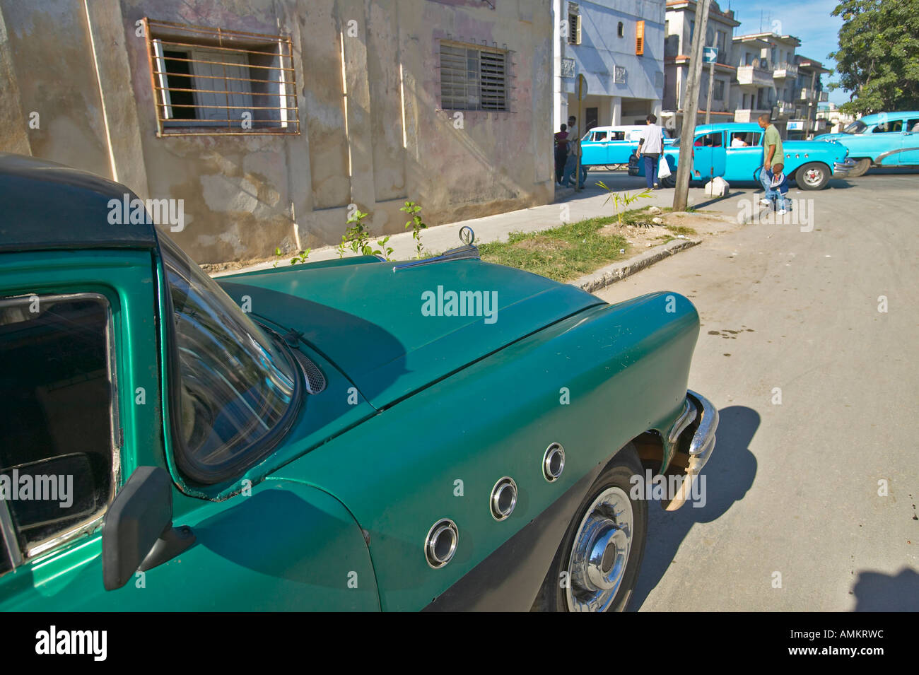 Old 1955 Buick parked with other old cars in distance of Havana Cuba Stock Photo