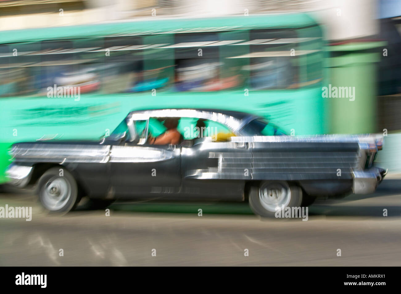 Mid 1950s black Oldsmobile speeding through Havana Cuba Stock Photo