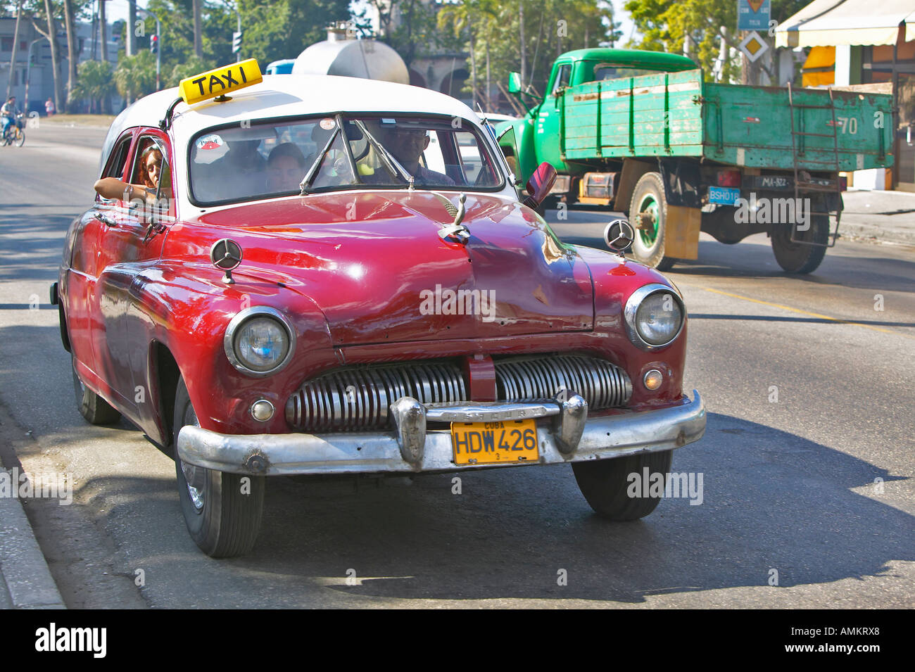 Old red taxi driving through the streets of Havana Cuba Stock Photo
