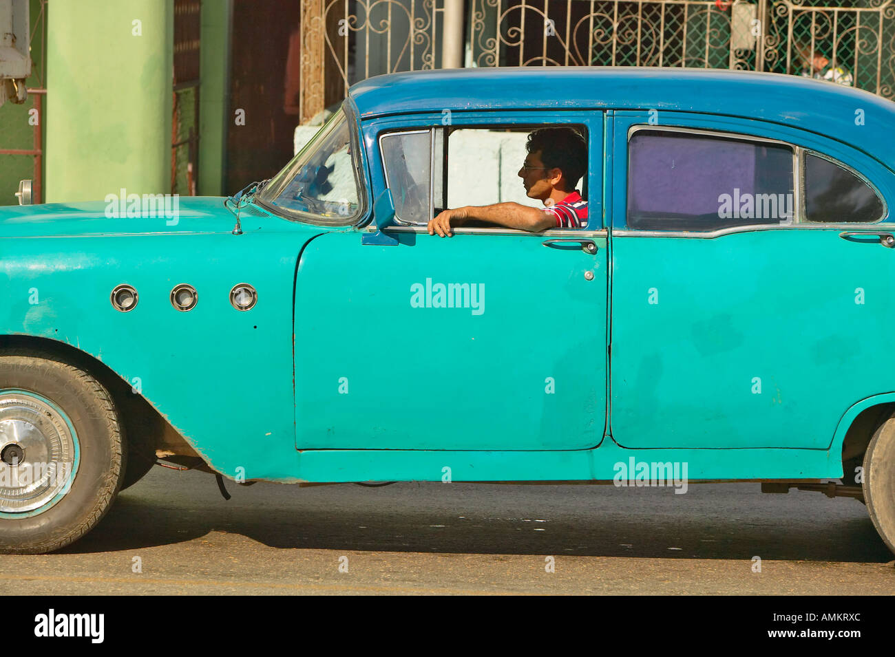 1955 old turquoise Buick driving through the streets of Havana Cuba Stock Photo