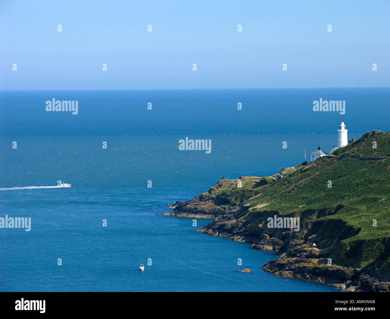 View of Start Point and it's lighthouse with motorboats on a sunny summer's day on the South Devon coast. UK Stock Photo