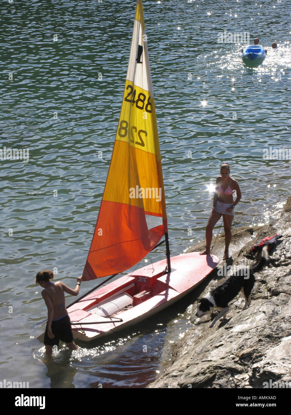 Two girls launching a Topper dinghy at Cellar Beach near Newton Ferrers