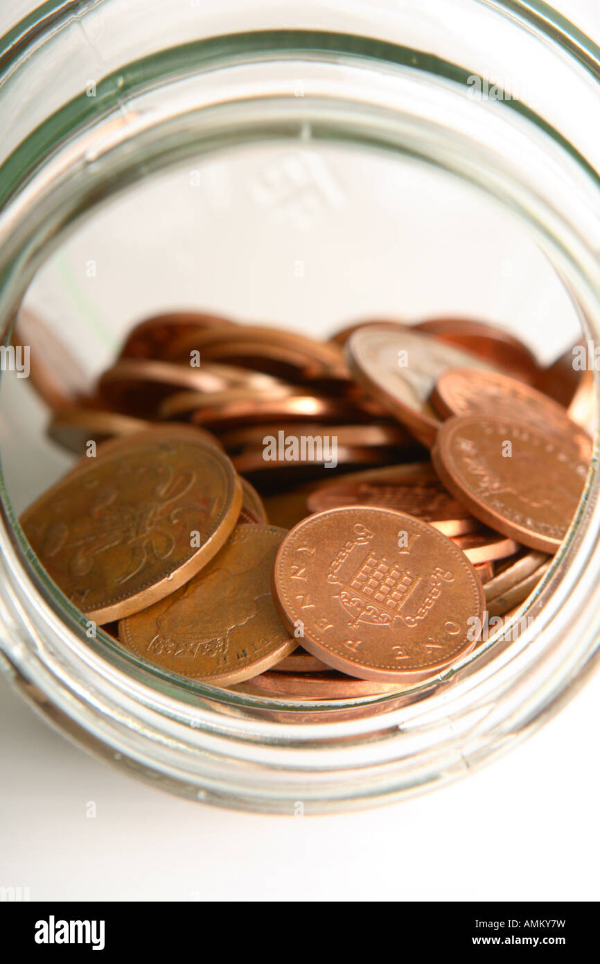 Saving money 1p penny coin cash and saving jar Stock Photo