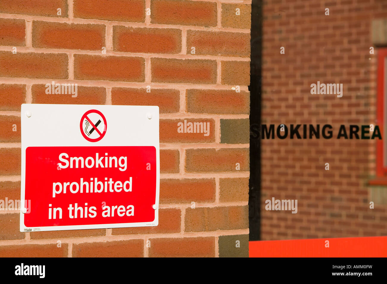 Smoking sign and a smoking shelter following the smoking ban Stock Photo