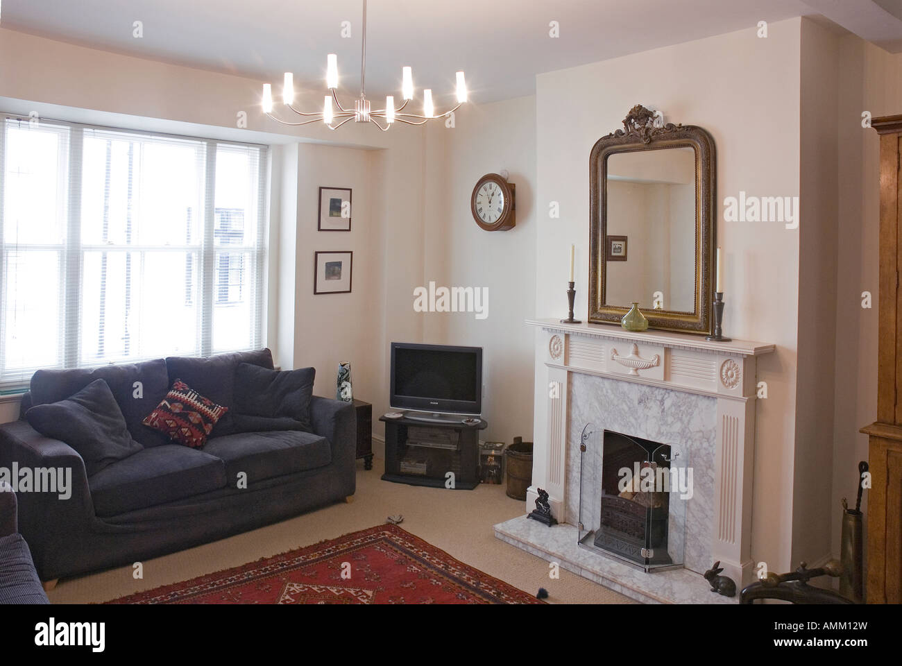 Living room with fireplace and mirror Stock Photo - Alamy