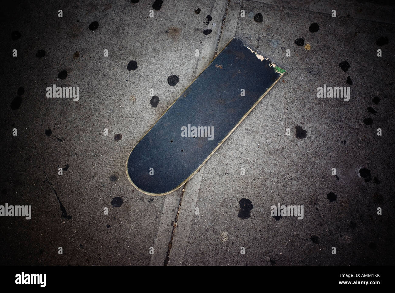 Skateboard broken in half on the sidewalk of New York City New York USA Stock Photo