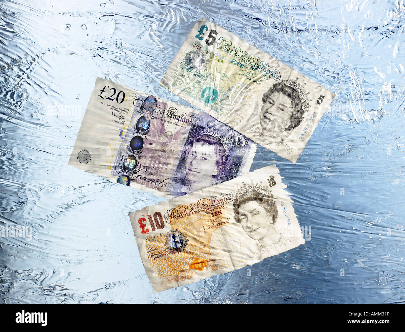 £5, £10 and £20 Pound notes encapsulated in Frozen Ice Stock Photo