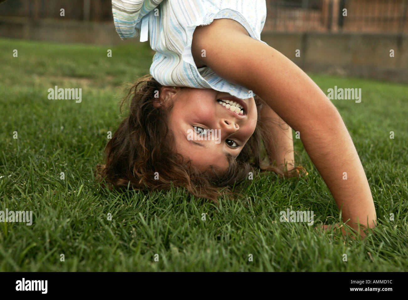 Little girl standing on her head Stock Photo - Alamy