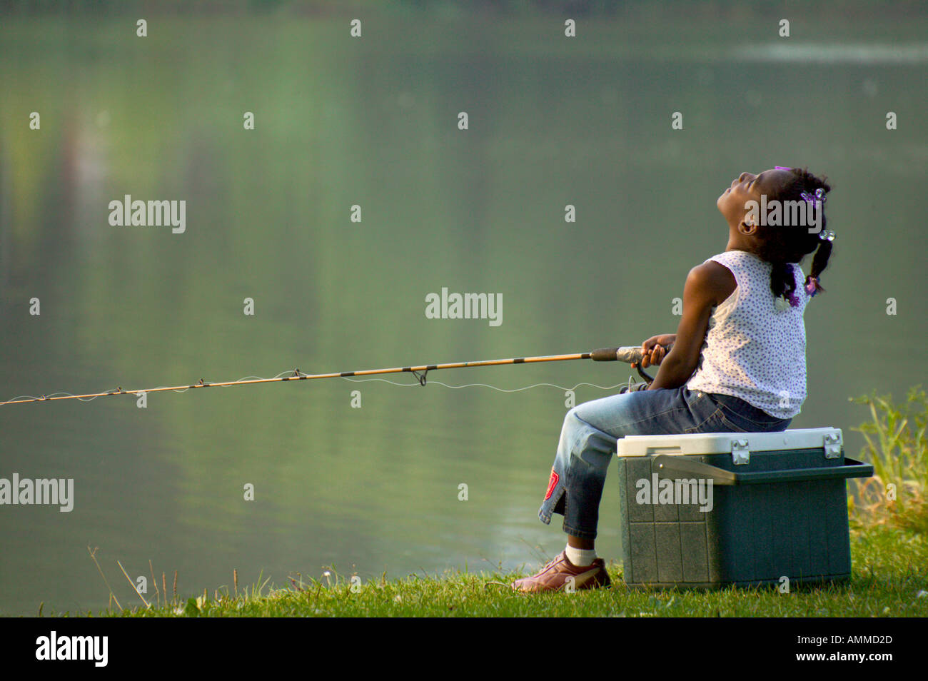 Little girl holding fishing rod on pond background Stock Photo - Alamy