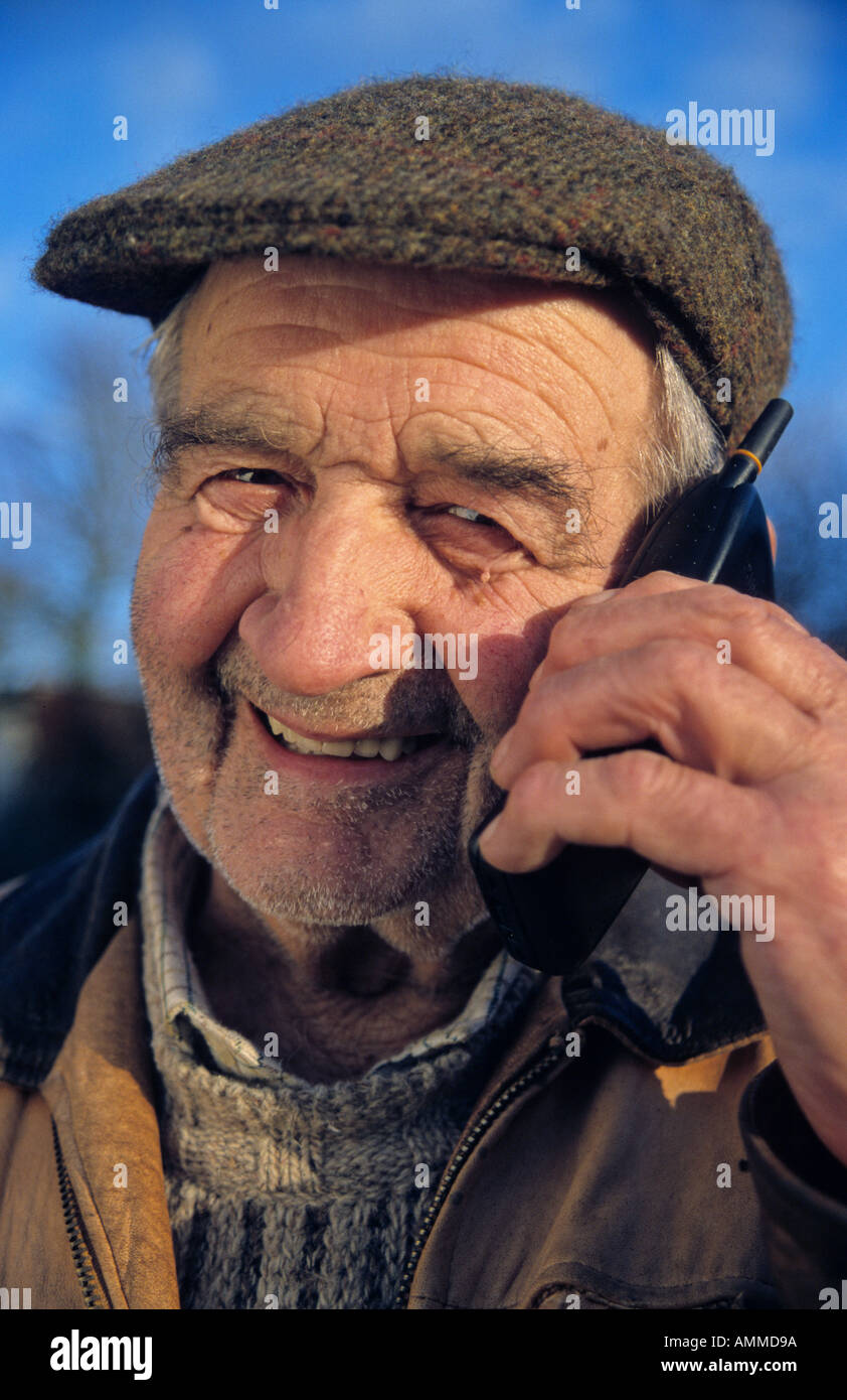 Elderly man using mobile phone Stock Photo